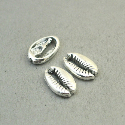 Shell charms, cowrie shell pendants. Two sided. Antique silver 12X19mm CM1859S